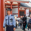 TOKYO, JAPAN - OCTOBER 31, 2017: Japanese policeman on the background of the temple Senso-ji. Close-up.