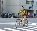 TOKYO, JAPAN - OCTOBER 31, 2017: A man in a beret with a bumbon rides a bicycle. Copy space for text.