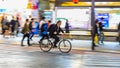 Night panning photography of unidentified man riding bicycle at Shibuya Square.The one of the wor