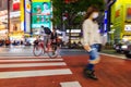 Night panning photography of unidentified man riding bicycle at Shibuya Square.The one of the wor
