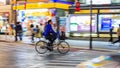 Night panning photography of unidentified man riding bicycle at Shibuya Square.The one of the wor