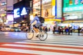 Night panning photography of unidentified man riding bicycle at Shibuya Square.The one of the wor