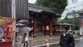 Elderlies with umbrellas a rainy day buying takoyaki octopus balls in Sugamo Jizo shopping street.