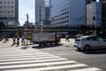 Tokyo, Japan, 26 October 2023: Pedestrians Crossing at a Tokyo Intersection with Overpass