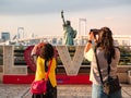 Tourist taking picture of Statue of Liberty in Odaiba area, Tokyo, Japan Royalty Free Stock Photo