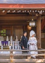 Japanese shinto wedding of a couple in kimono under a lantern of the Meiji Shrine. Royalty Free Stock Photo