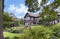 Western-style mansion of KyÃÂ«-Furukawa Gardens with tourists sightseeing the rose garden.