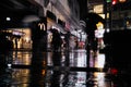 Tokyo, Japan - 11/6/2018: People walking down a wet street in Koenji at night