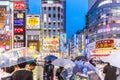 Tokyo, Japan - Sep 28th 2018 - Big group of people with umbrellas in a bright colorful place in Tokyo in Japan