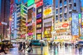 Tokyo, Japan - Sep 28th 2018 - Big group of people walking around a very colourful and bright area of Tokyo in a wet day in Japan