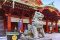 Stone statue of a komainu lion in front of the Japanese Shintoist Kanda shrine. Royalty Free Stock Photo