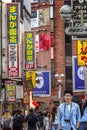 Tokyo, Japan, 04/12/2019: Traffic of people on a busy street with shops and restaurants in the city. Vertical Royalty Free Stock Photo