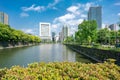 Tokyo, Japan - 12.05.2019: Water canal and stone wall of Emperor Palace complex viewed from Iwaida Bridge. Skyscrapers reflect in