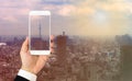 Tokyo rooftop view : Handholding smartphone over Tokyo cityscape background.