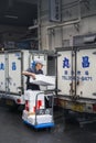 Worker at Japanese fish market loading iced seafood