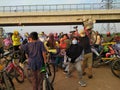 People's who are lifting bicycles, passing the road divider portal