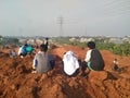 Tol cibitung Cilincing, Bekasi, Indonesia - (16-08-2020) : Local residents are playing on a pile of red dirt