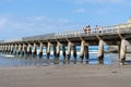 Long repeating pattern and diminishing perspective and shadow of structure underneath Tolaga Bay Wharf, East Coast New Zealand Royalty Free Stock Photo
