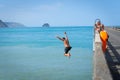 Local boys jumping of Tolaga Bay Wharf