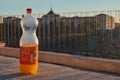 Toledo, Castilla La Mancha, Spain; December 23 2.017: Orange Fanta bottle with the Infantry Academy of Toledo in the background