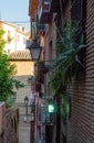 Toledo, Castilla-La Mancha, Spain. Old medieval town, narrow street, church. Flowers in window