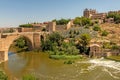 Alcazar and Alcantara Bridge Puente de Alcantara, an arch bridge in Toledo Royalty Free Stock Photo