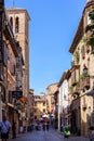 Calle de Santo Tome narrow medieval cobbled street with shops, hotels, restaurants, Toledo, Spain.