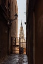 View of the tower of the cathedral of Toledo through a narrow alley in the medieval city Royalty Free Stock Photo