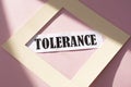 Tolerance text in a beige frame on a pink background. Equality, diversity and tolerance social concept
