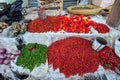 Toliara, Madagascar - May 01, 2019: Dried red and green peppers and spices, in vivid contrast colours, displayed on street food