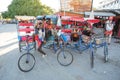 Toliara, Madagascar - May 01, 2019: Group of unknown Malagasy men with their bicycle rickshaw carts waiting for passengers, posing Royalty Free Stock Photo