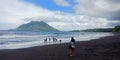 Tolire beach location during the day with a very sunny mountain background