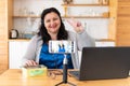 A tolstaya woman leads a video blog in a room, in the office. Royalty Free Stock Photo