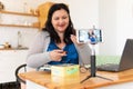 A tolstaya woman leads a video blog in a room, in the office. Royalty Free Stock Photo