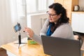 A tolstaya woman leads a video blog in a room, in the office. Royalty Free Stock Photo