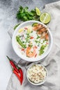 Tom Kha Gai. Spicy creamy coconut soup with chicken and shrimp. Thai food. gray background. Top view