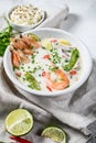 Tom Kha Gai. Spicy creamy coconut soup with chicken and shrimp. Thai food. gray background. Top view