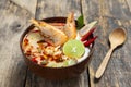 Tom Yam Kung Prawn and lemon soup with mushrooms, thai food in wooden bowl top view Royalty Free Stock Photo