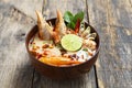 Tom Yam Kung ,Prawn and lemon soup with mushrooms, thai food in wooden bowl top view Royalty Free Stock Photo