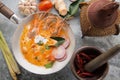 Tom Yum Goong Spicy Sour Soup on wooden table top view, famous Thai food cuisine calling Tom Yum Kung Royalty Free Stock Photo