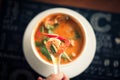 Tom Yum Goong thai hot spicy soup on wooden table,Thai popular food menu Royalty Free Stock Photo