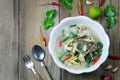 Tom Yum Grouper Fish Spicy Soup of Thai food in a bowl on wooden floor