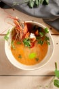 Tom yum soup in beige ceramic bowl top view Royalty Free Stock Photo