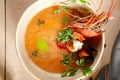 Tom yum soup in beige ceramic bowl top view Royalty Free Stock Photo