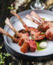 Tomahawk rib beef steak on bone with sauce on plate over marble background. Hot Meat Dishes, top view, selective focus Royalty Free Stock Photo