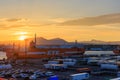 Tomakomai, Japan - August 30, 2023: Cargo trucks in parking lot by docked ship at sunset