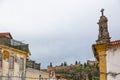 View of a classic element on cornice building in Tomar city downtown, with Convent of Christ building as background