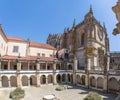 View at the Hospedaria cloister, Lodging cloister, Charola gothic main building as background, tourist people visiting, UNESCO