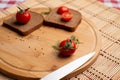 Tomates with black bread for lunch, Black bread with tomato on the wooden background Royalty Free Stock Photo