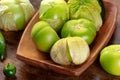 Tomatillos, green tomatoes, Mexican cuisine ingredient on a wooden background Royalty Free Stock Photo